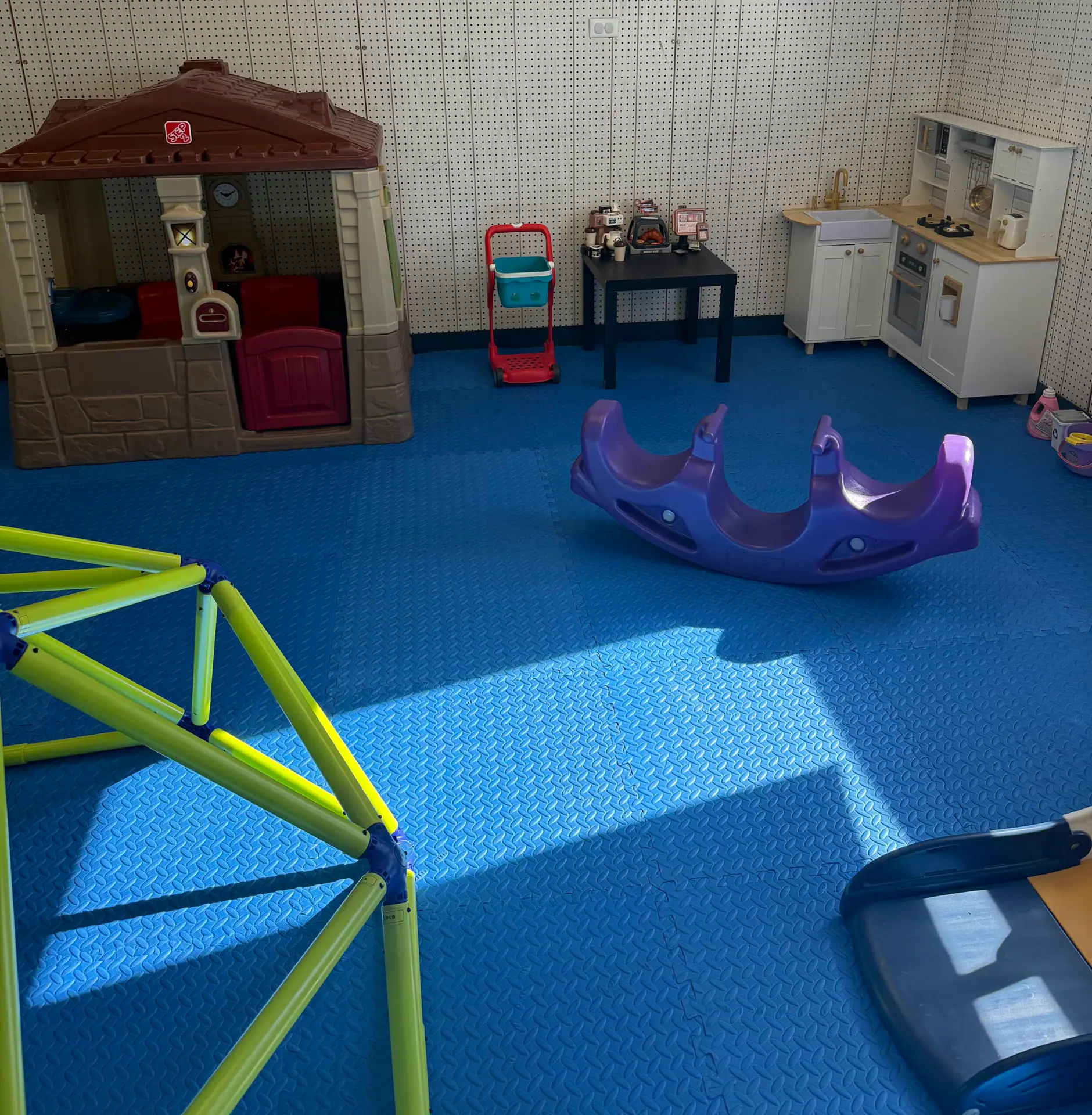Pretend play kitchen and playhouse inside Garden City Fun Zone