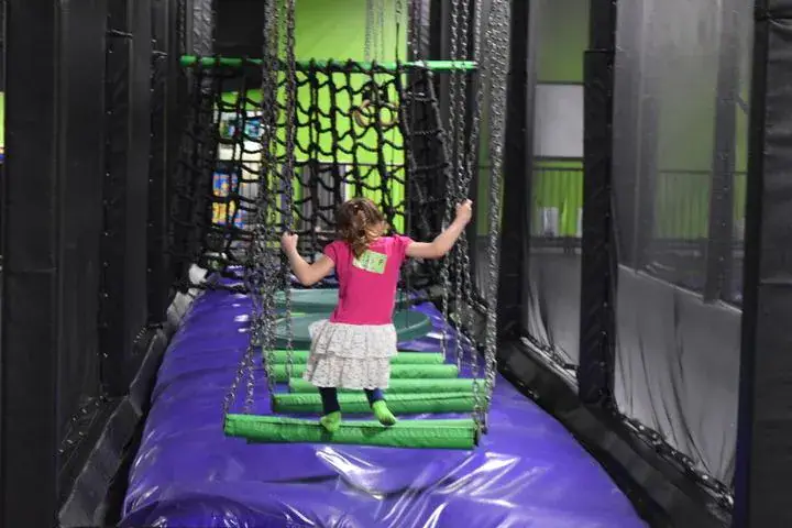 Child crossing a suspended obstacle inside Action City.