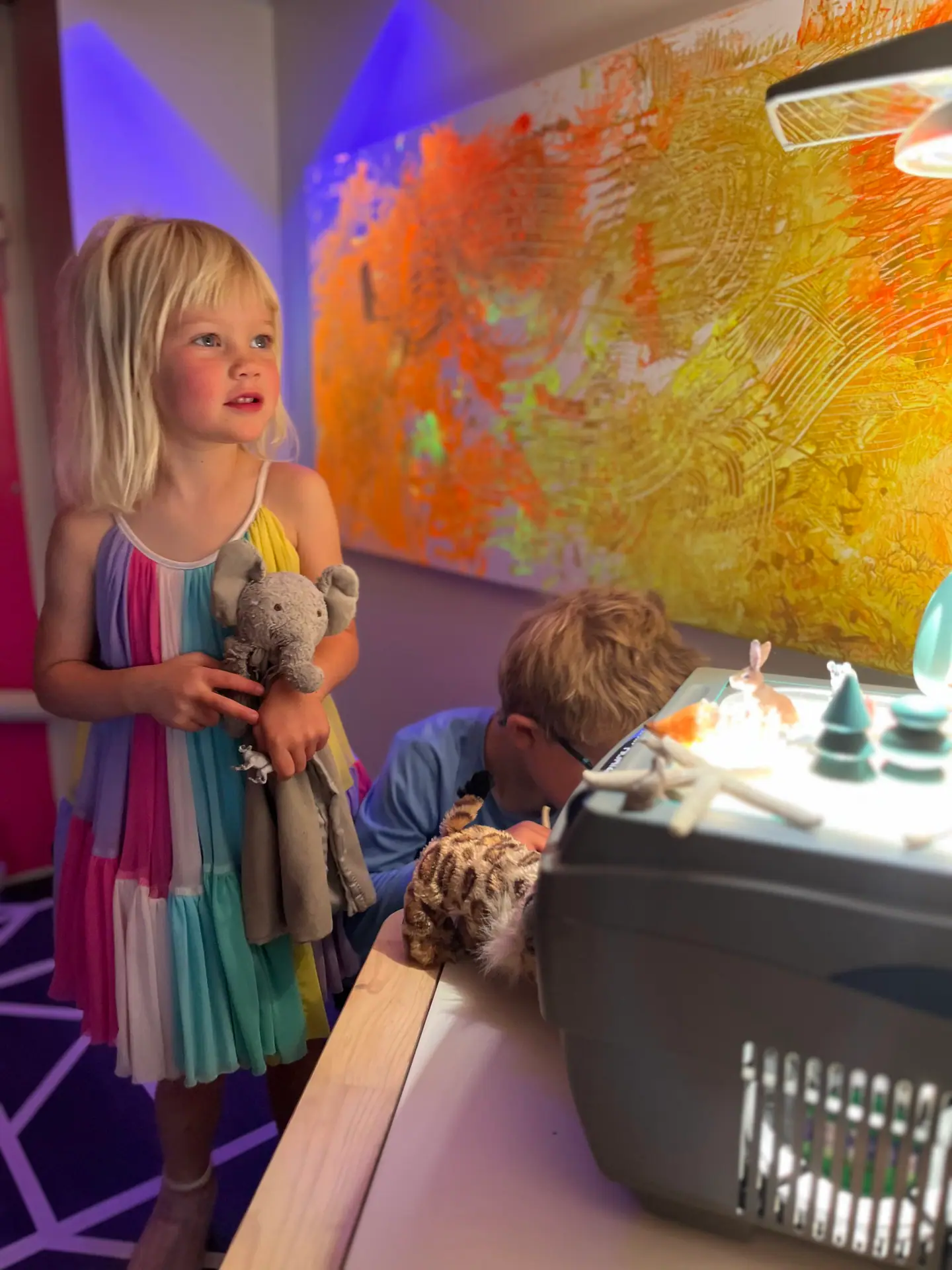 Children exploring the glow cave sensory area at State of Play
