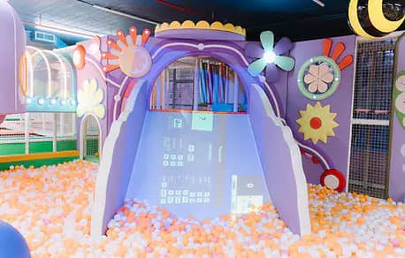 PeekabooO soft play with ball-pit tunnel and digital projection play wall.