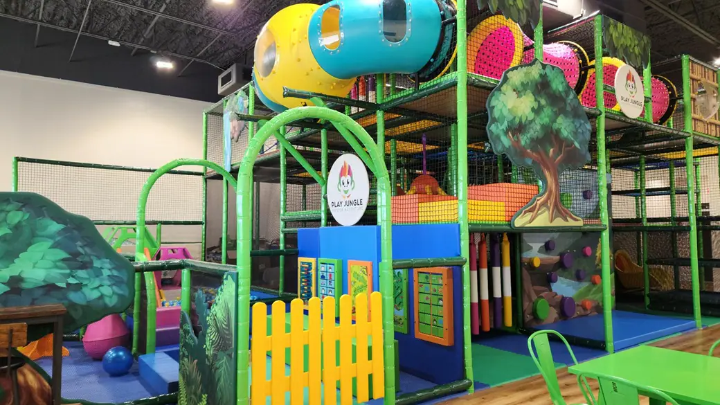 Three-level jungle-themed play structure at Play Jungle Indoor Adventure