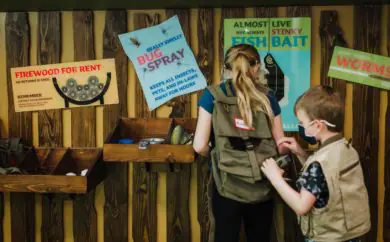 Children interacting with a camp-themed exhibit at kidscommons.