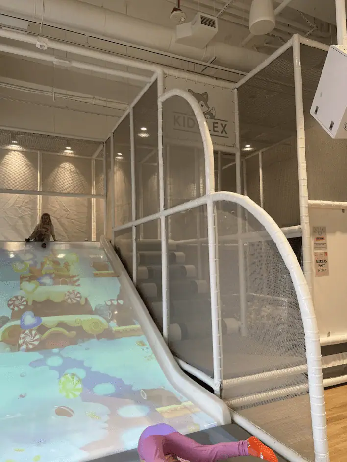 Slide and climbing play structure at Kidplex.