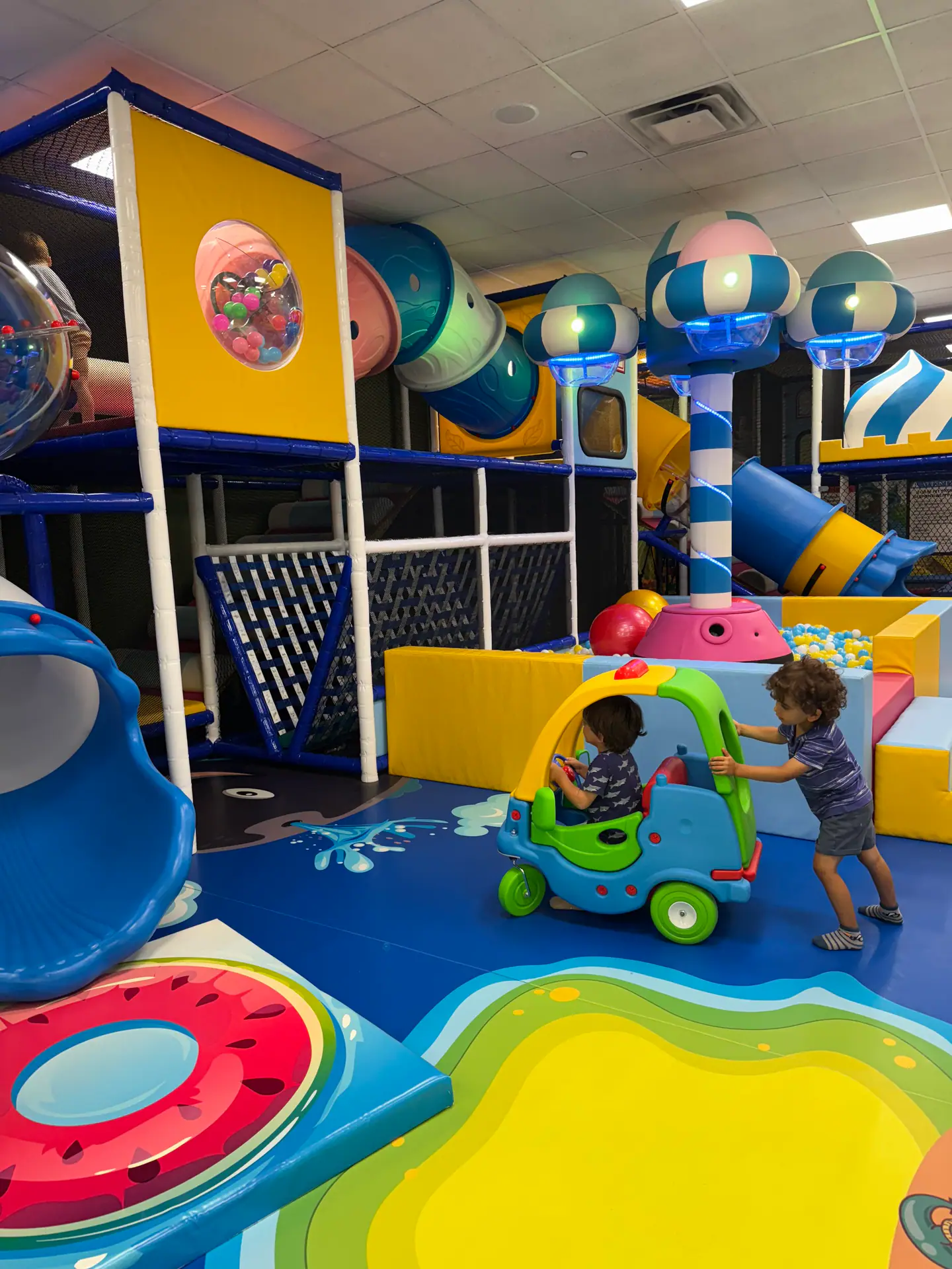 Colorful indoor play equipment at JJ's Playhouse.