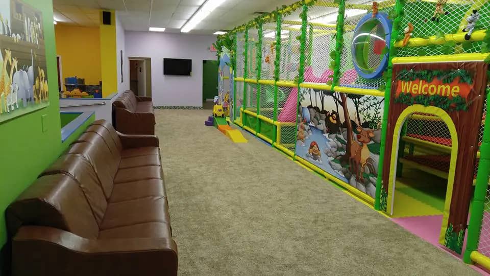 Seating area beside the play structure at Kiddie Jungle Mentor.