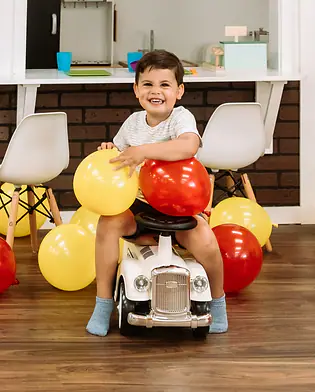 Young child using a ride-on toy at Funtown Play Cafe.