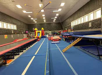 Tumbling lanes, trampolines, and gym equipment inside TDC Athletics in Spring Creek.
