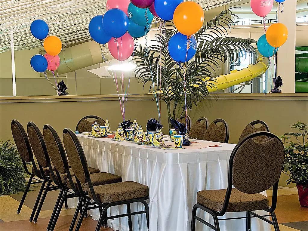Birthday party table setup overlooking the indoor waterpark at King's Pointe.