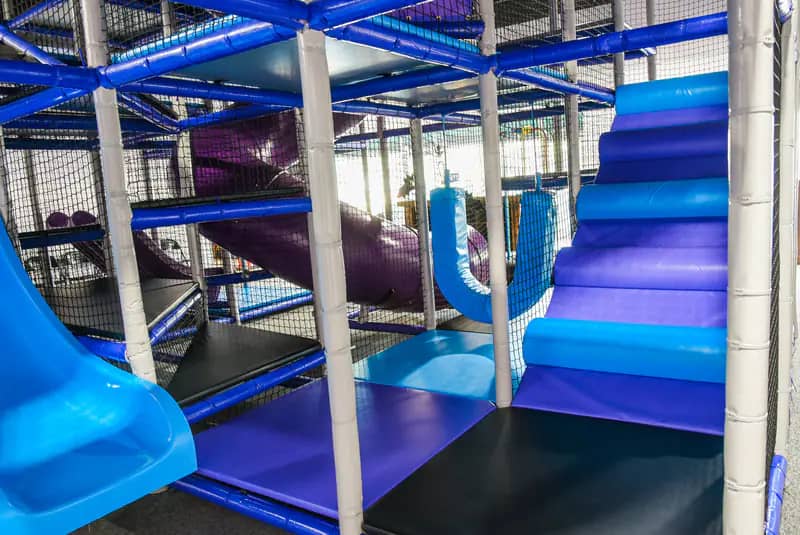 Children's indoor play area with bright padded structures and slide elements at InPlay! Family Fun.