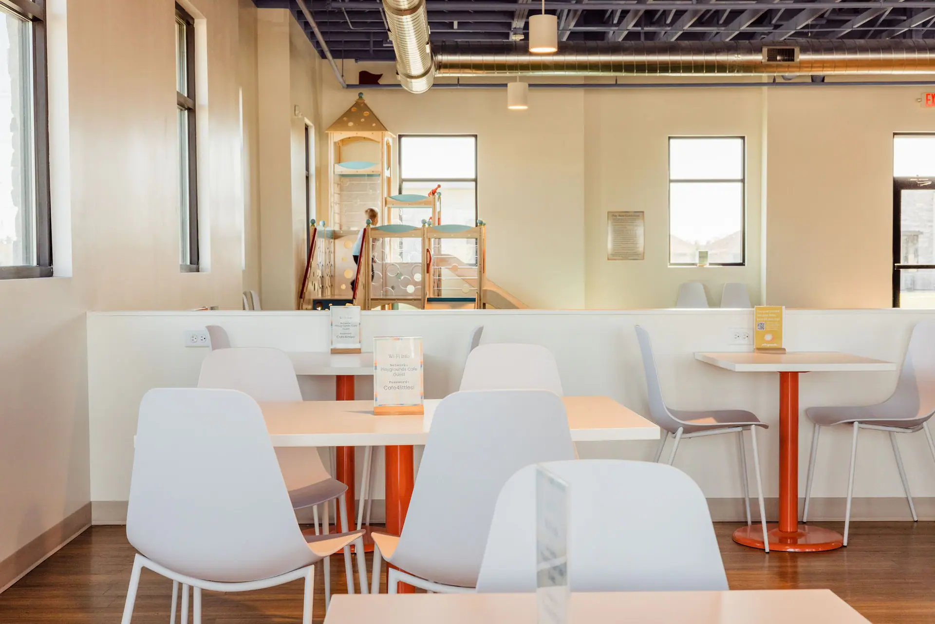 Cafe seating overlooking the play area at PLAYgrounds Cafe