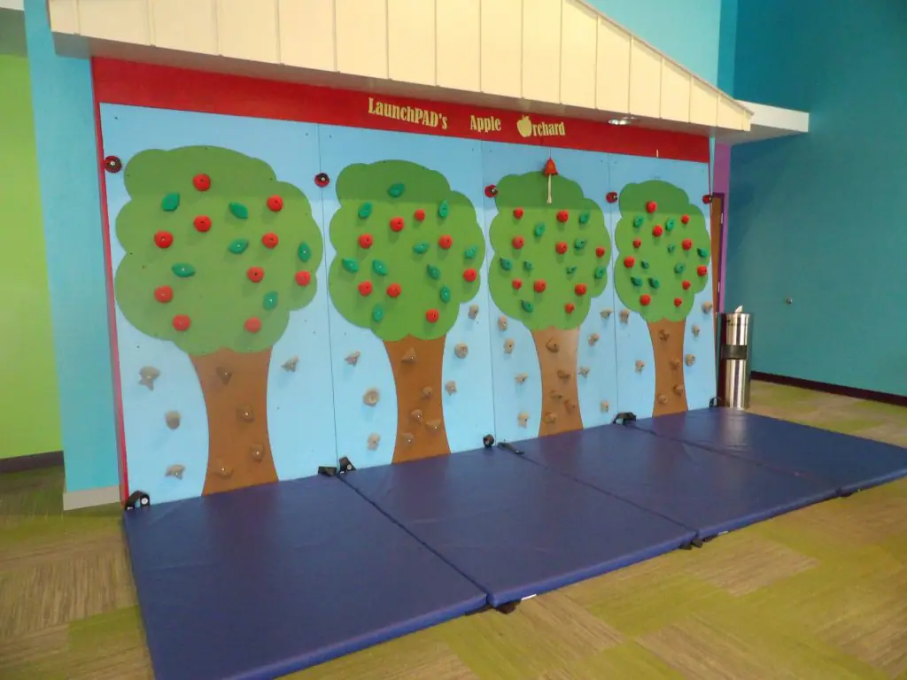 Apple orchard themed climbing wall at LaunchPAD Children's Museum.