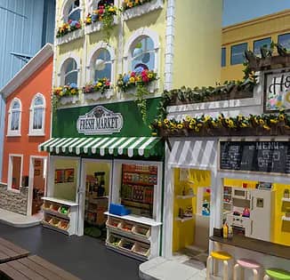 Pretend-play mini town area at The Bee's Knees Play Cafe.
