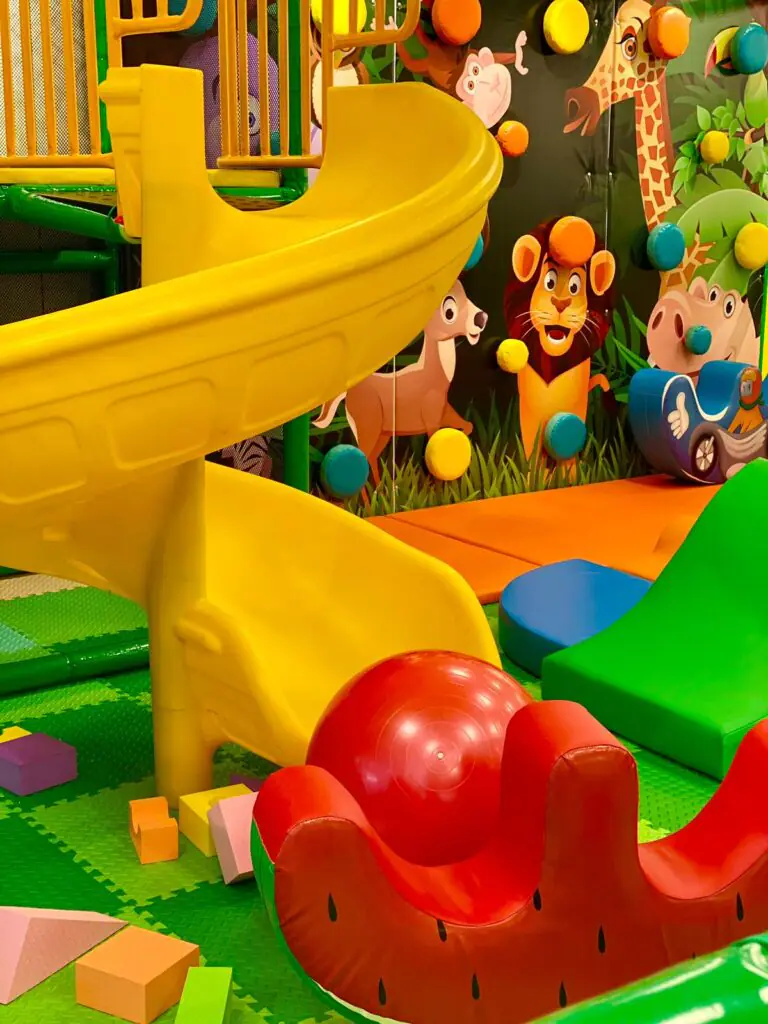 Colorful Go Playland play structure with climbing and slide features.
