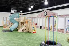 Wide view of the main play structure and floor space at Little Explorers Play Cafe.