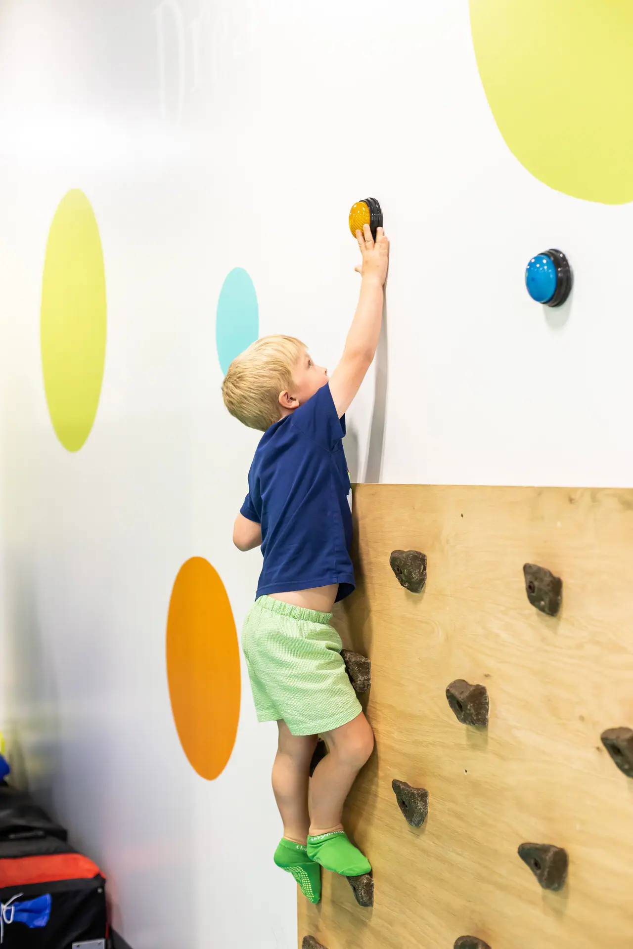 Child climbing and exploring soft-play equipment at Chee Chee's Playroom.