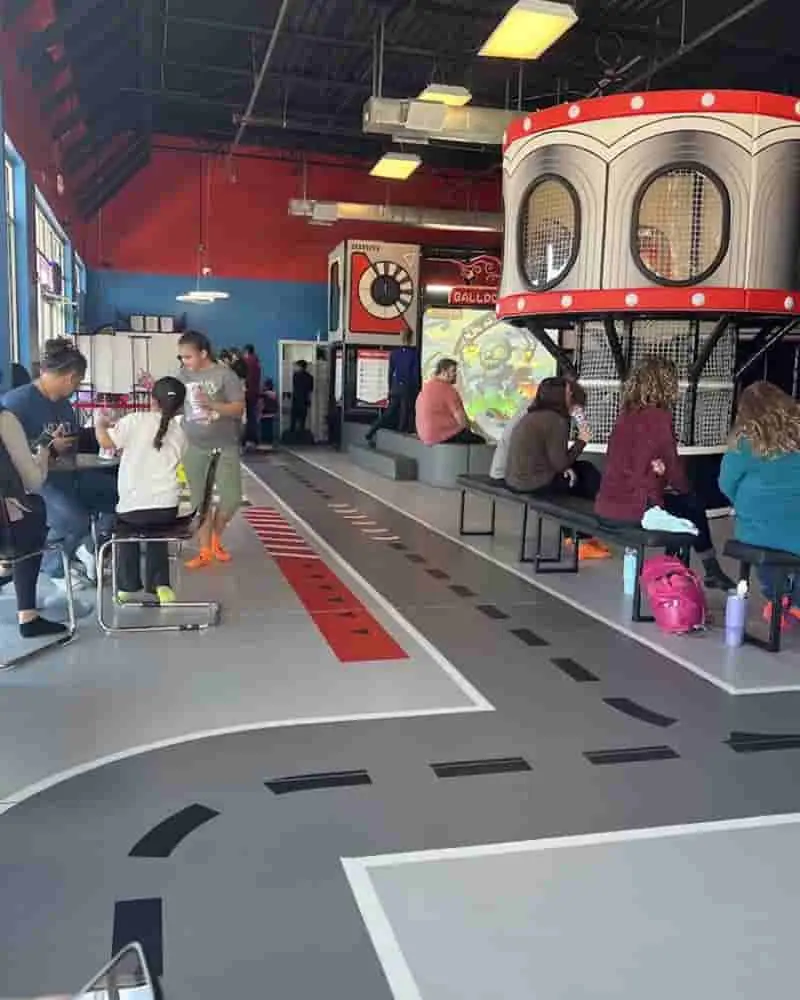 Seating area beside the play structure at Ninja Kingdom Adventure Park.