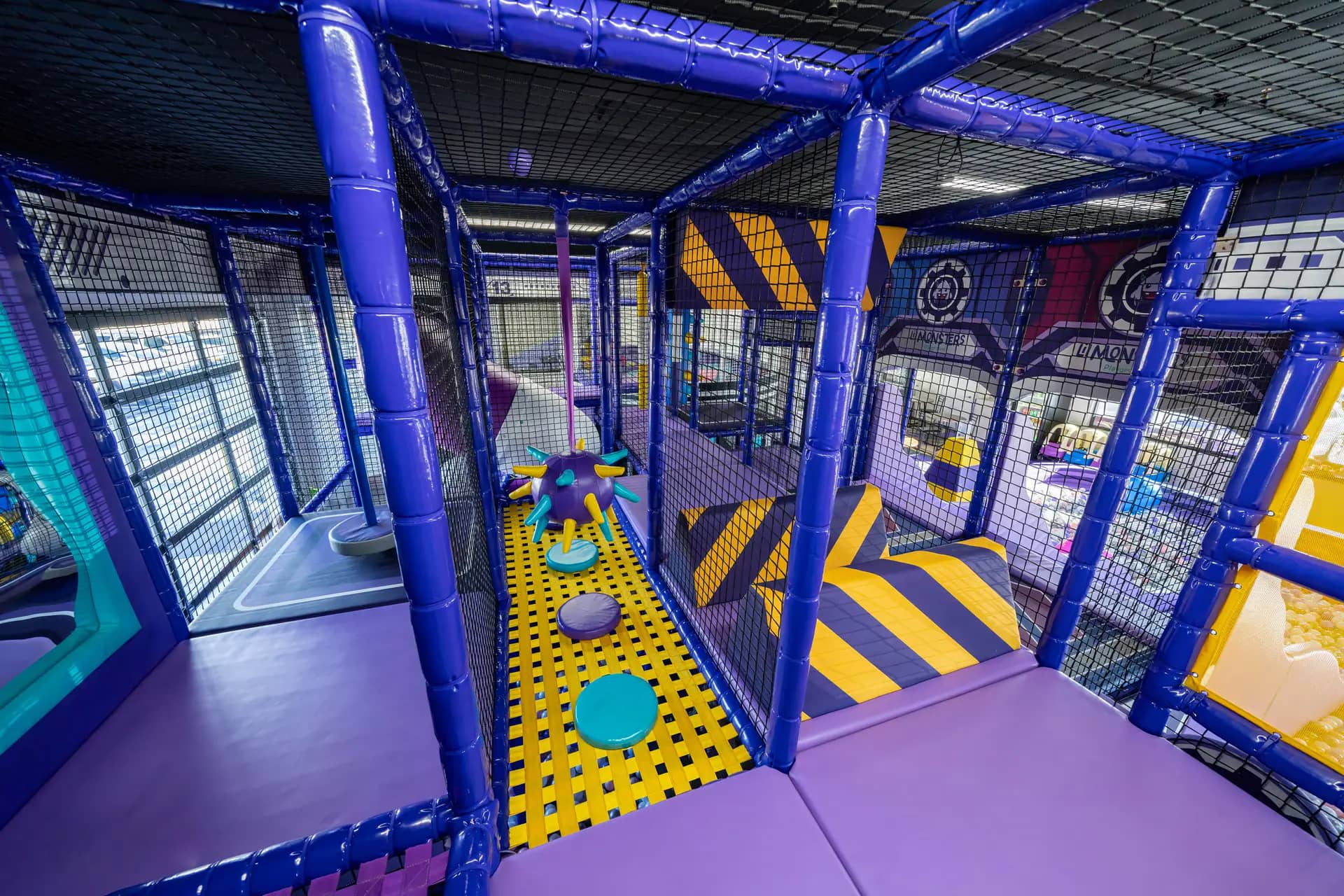 Upper-level obstacle and tunnel area inside Lil Monsters Playground.