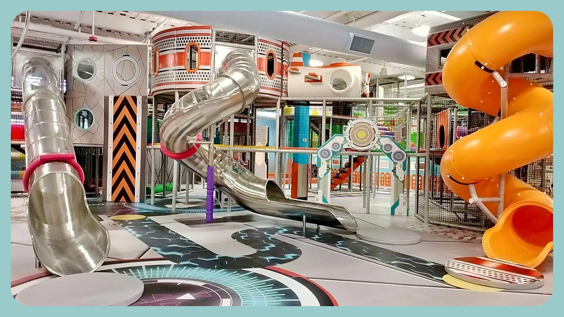 Large indoor play structure with tall slides at Adventure Palace.