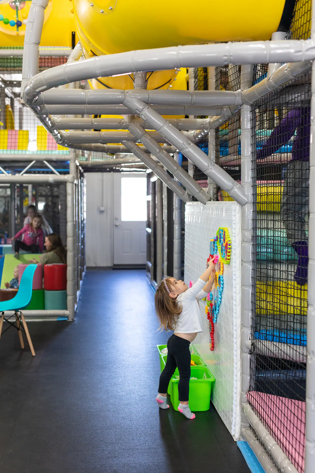 Children’s indoor playground area at KinderZone with padded play features.