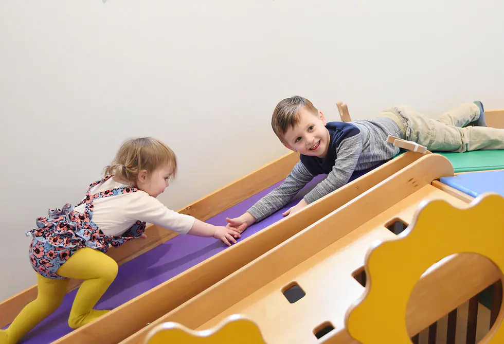 Open play setup at Little Buffalo with child-sized materials and room for caregivers to supervise.