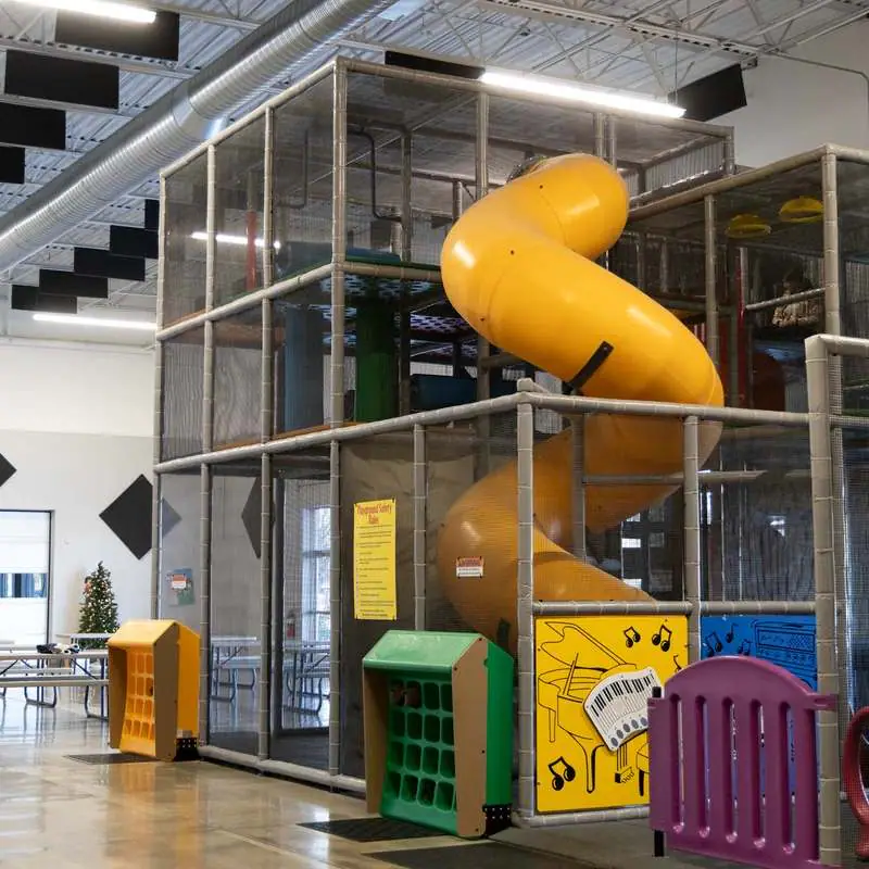 Multi-level indoor playscape with tube slide at The Point in South Portland.