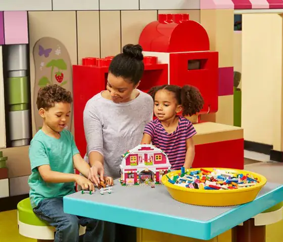 Children exploring a colorful LEGO Friends themed area at the attraction