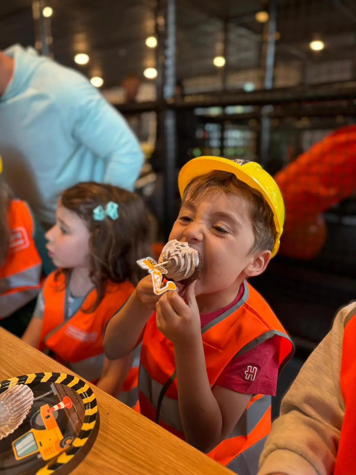 Children using construction-themed hands-on play stations at Construction Corner.