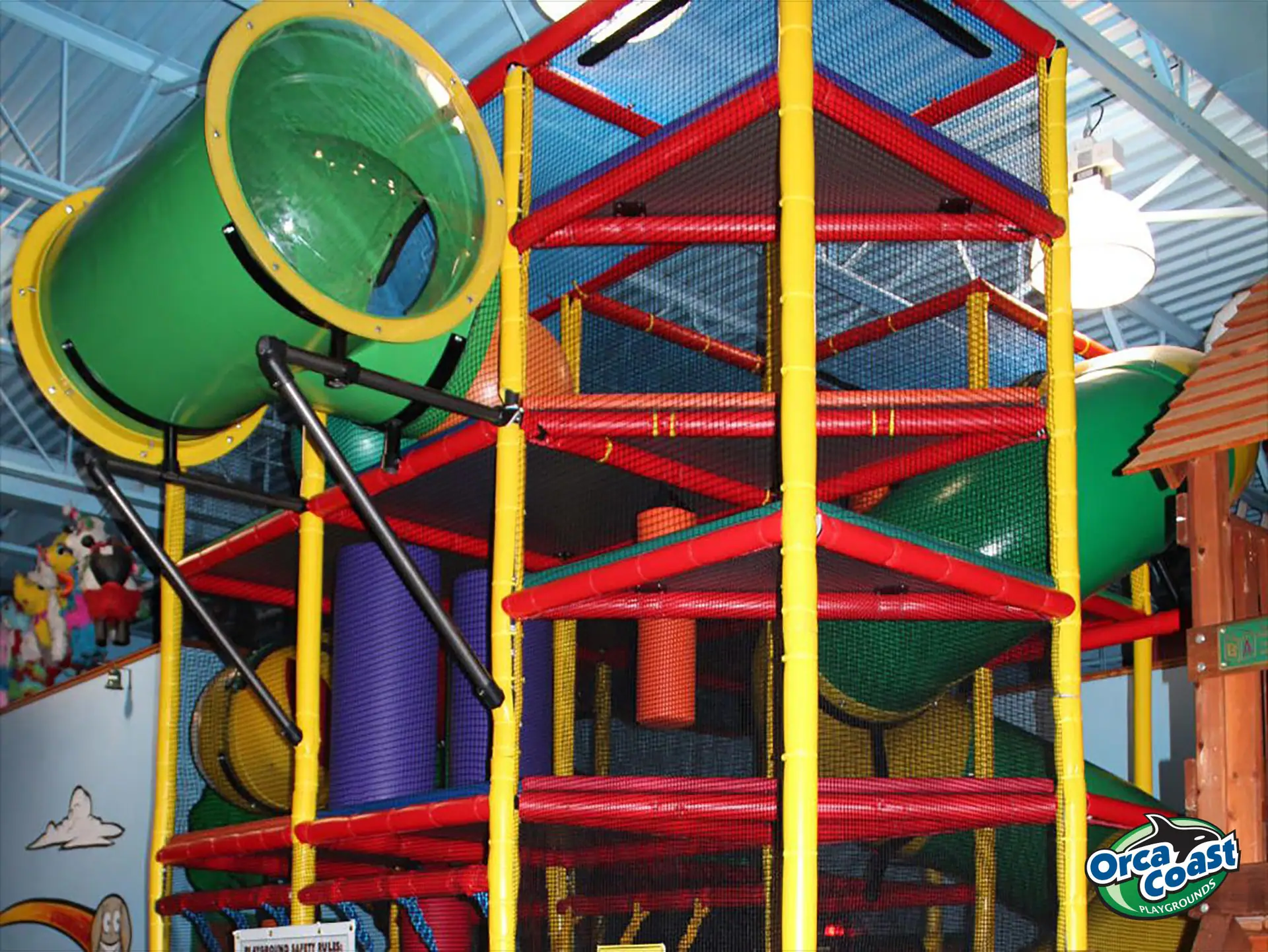 Colorful indoor climbing structure with enclosed tube slides at Lost in Fun in Lincoln.