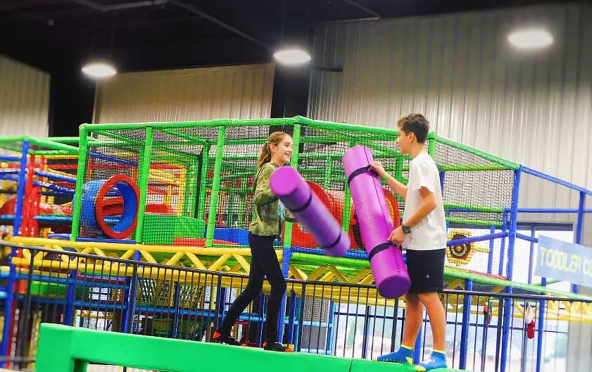 Kids using a padded challenge attraction at Velocity 360 Fun Park.
