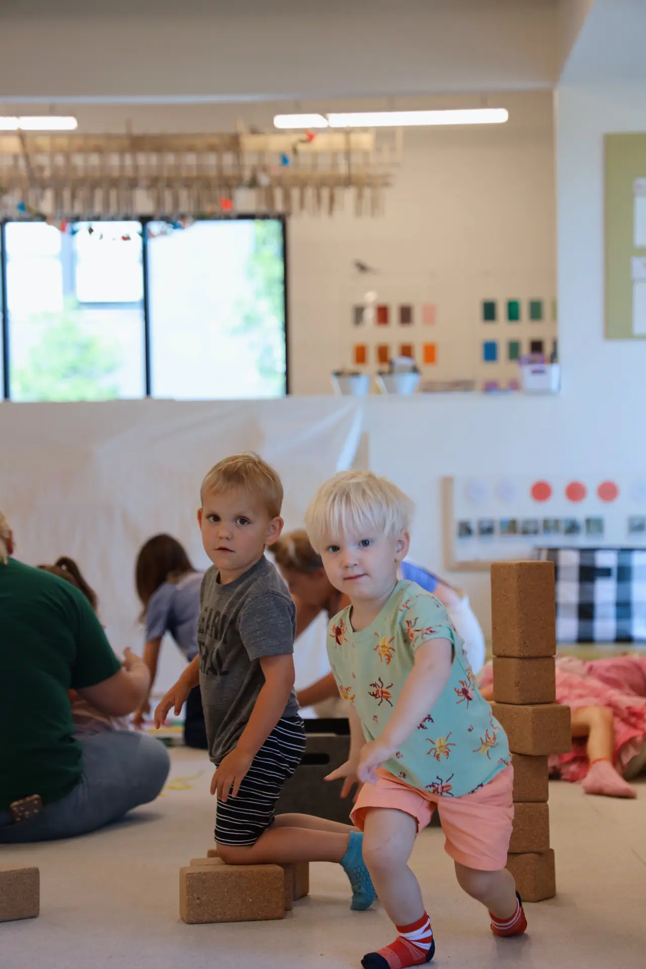 Young children doing block play in the open-play room at State of Play