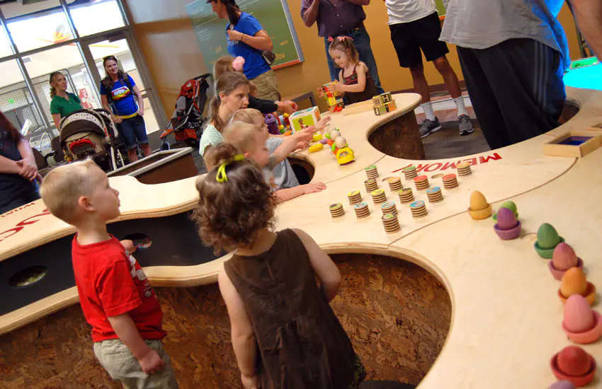 Children exploring hands-on exhibits inside The Discovery in Reno.