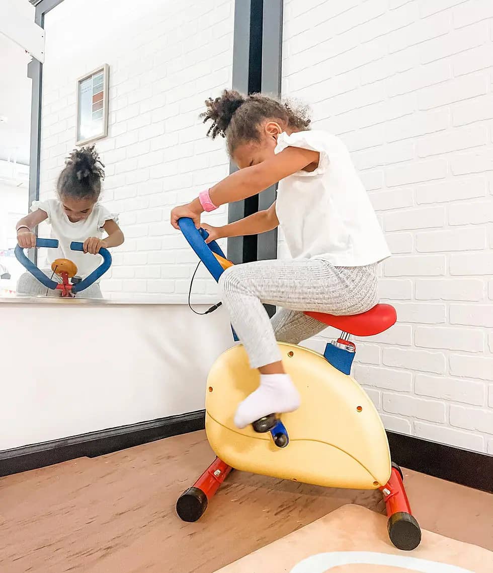 Child using ride-on pretend-play equipment at Play À La Mode