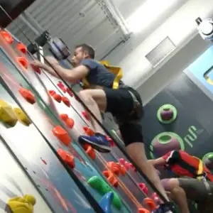Child climbing a colorful wall at Play Climb.
