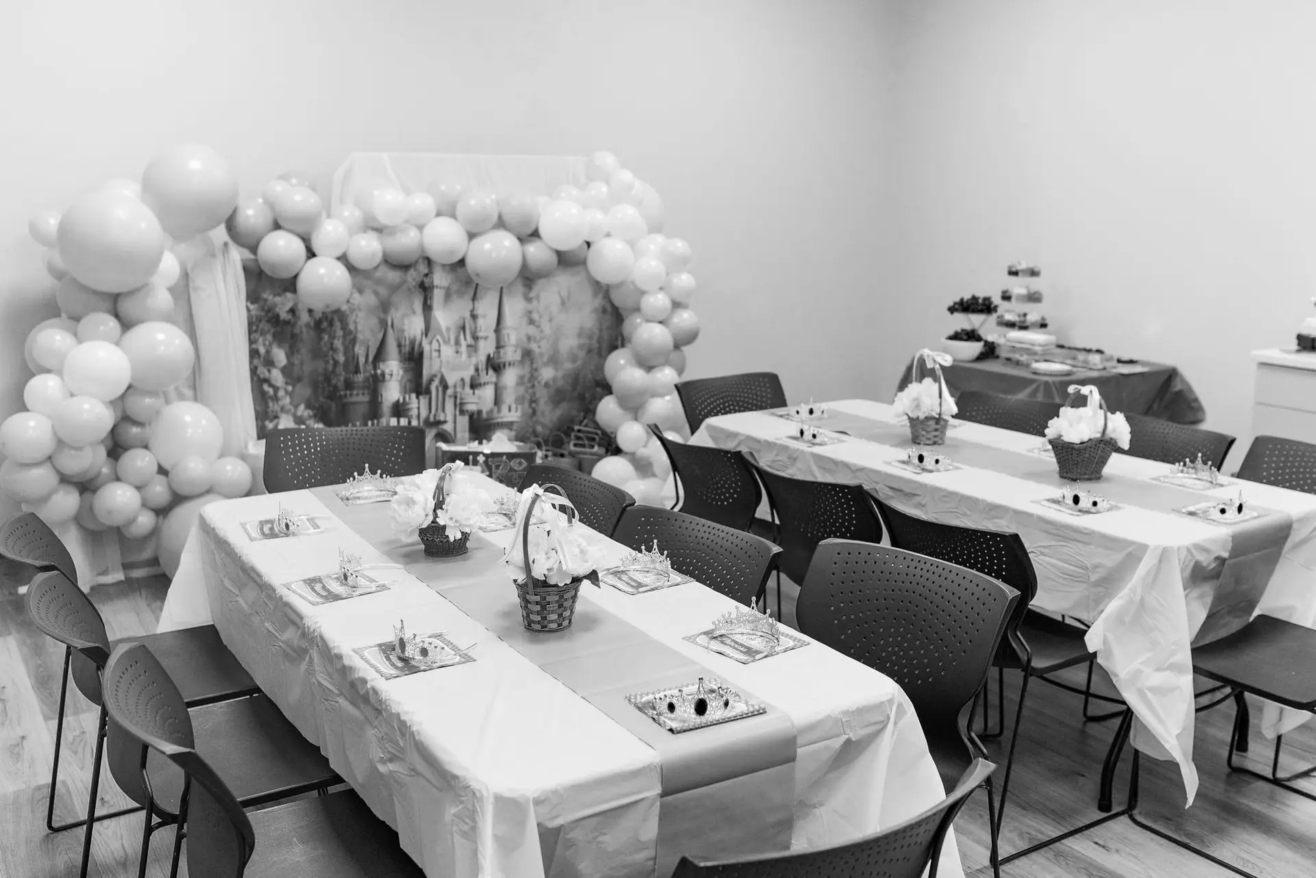 Party room at The Community Center at Crossroads with tables and seating.