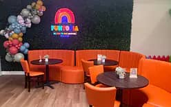 Orange booth seating and lounge area inside Funtopia.