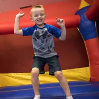 Child playing in a bouncy play area at Jam Time.