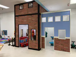 Pretend-play firehouse and medical center area inside Rainforest Play Zone in Juneau.