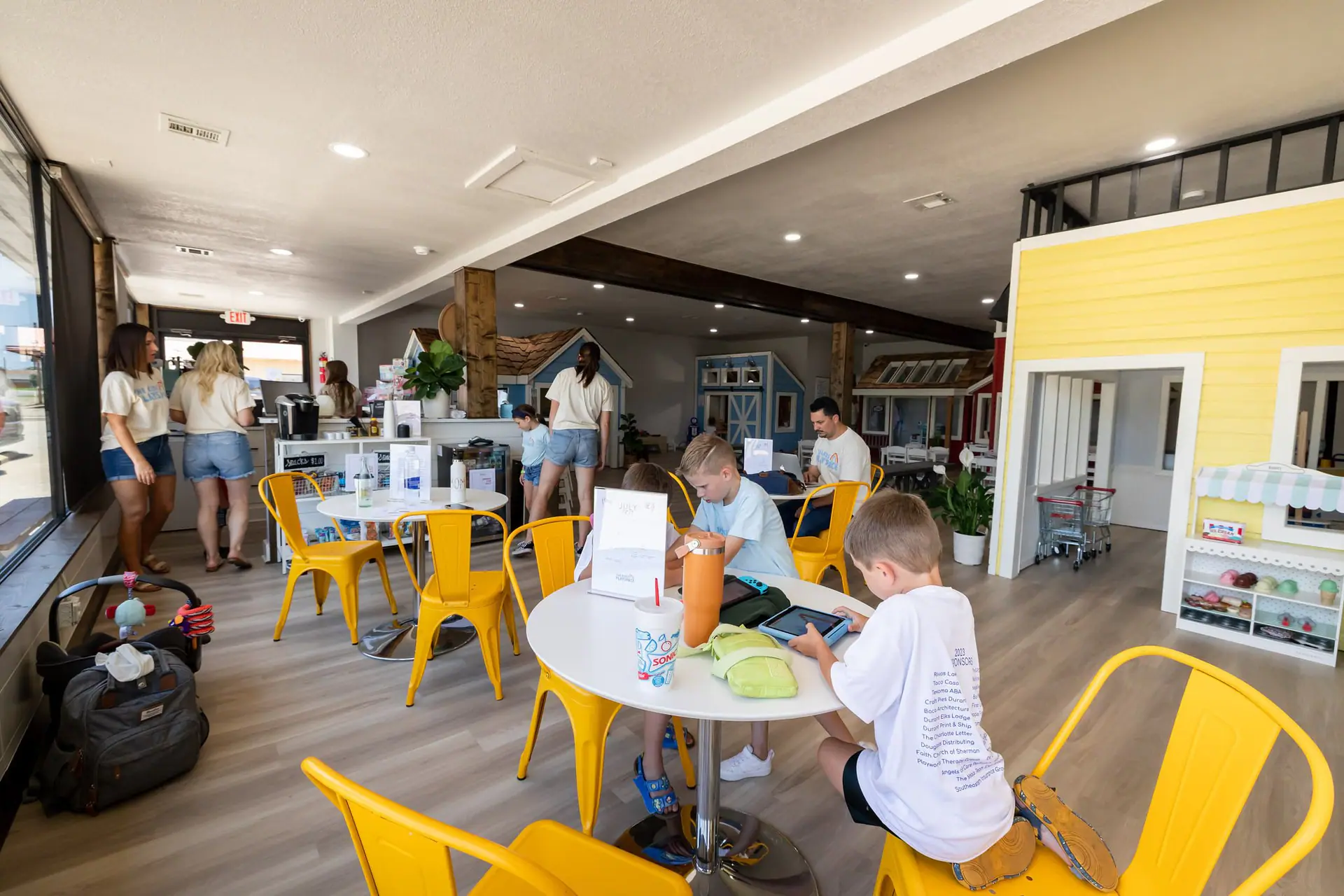 Open play setup with caregiver-friendly seating at The Kids’ Playspace.