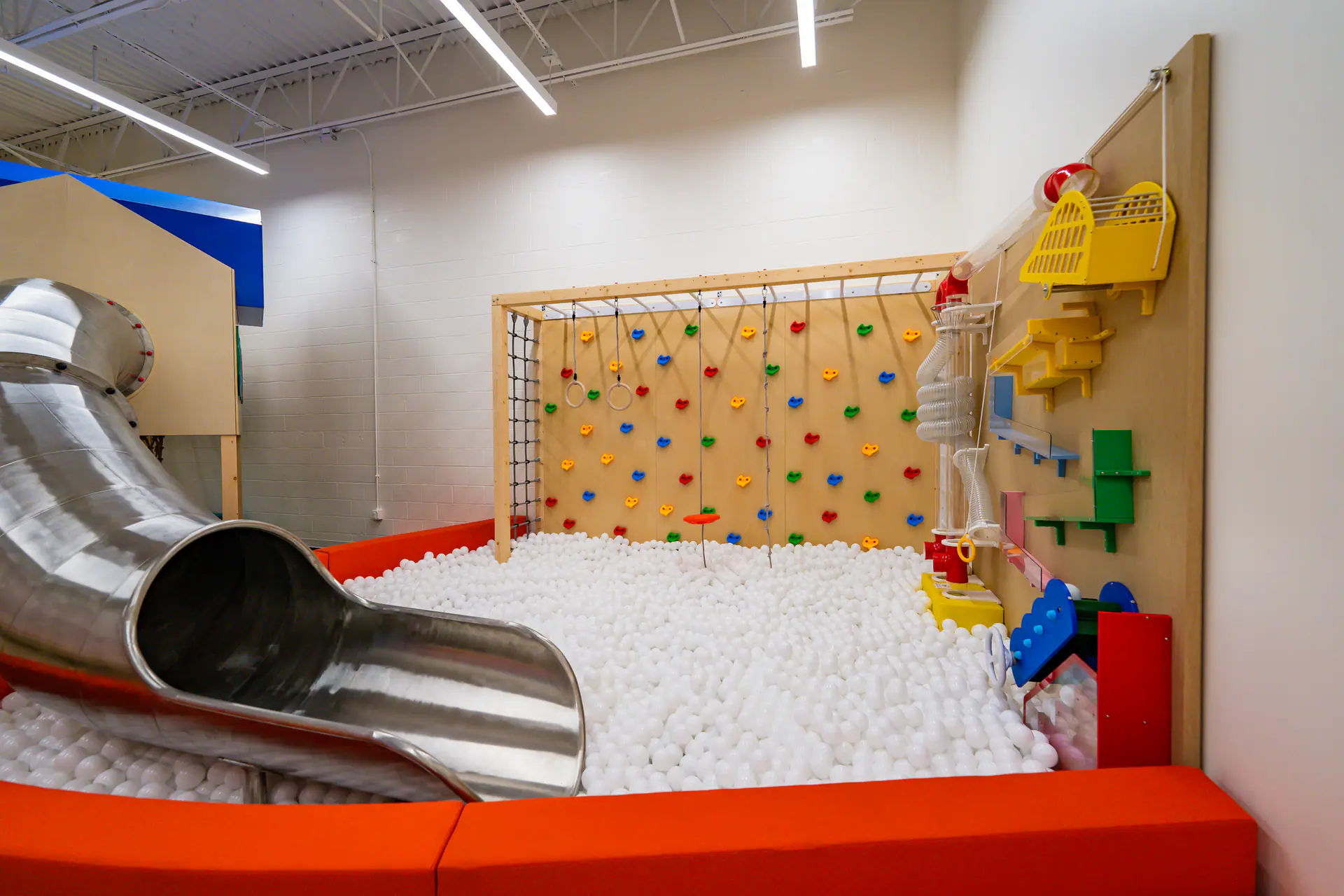 Indoor play equipment and open circulation space at Playground Abode.