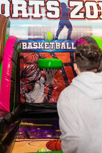 Guest shooting at the inflatable basketball game area at Bounce City Idaho Falls.