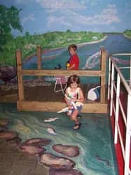 Children use a hands-on fishing-themed exhibit at the museum.