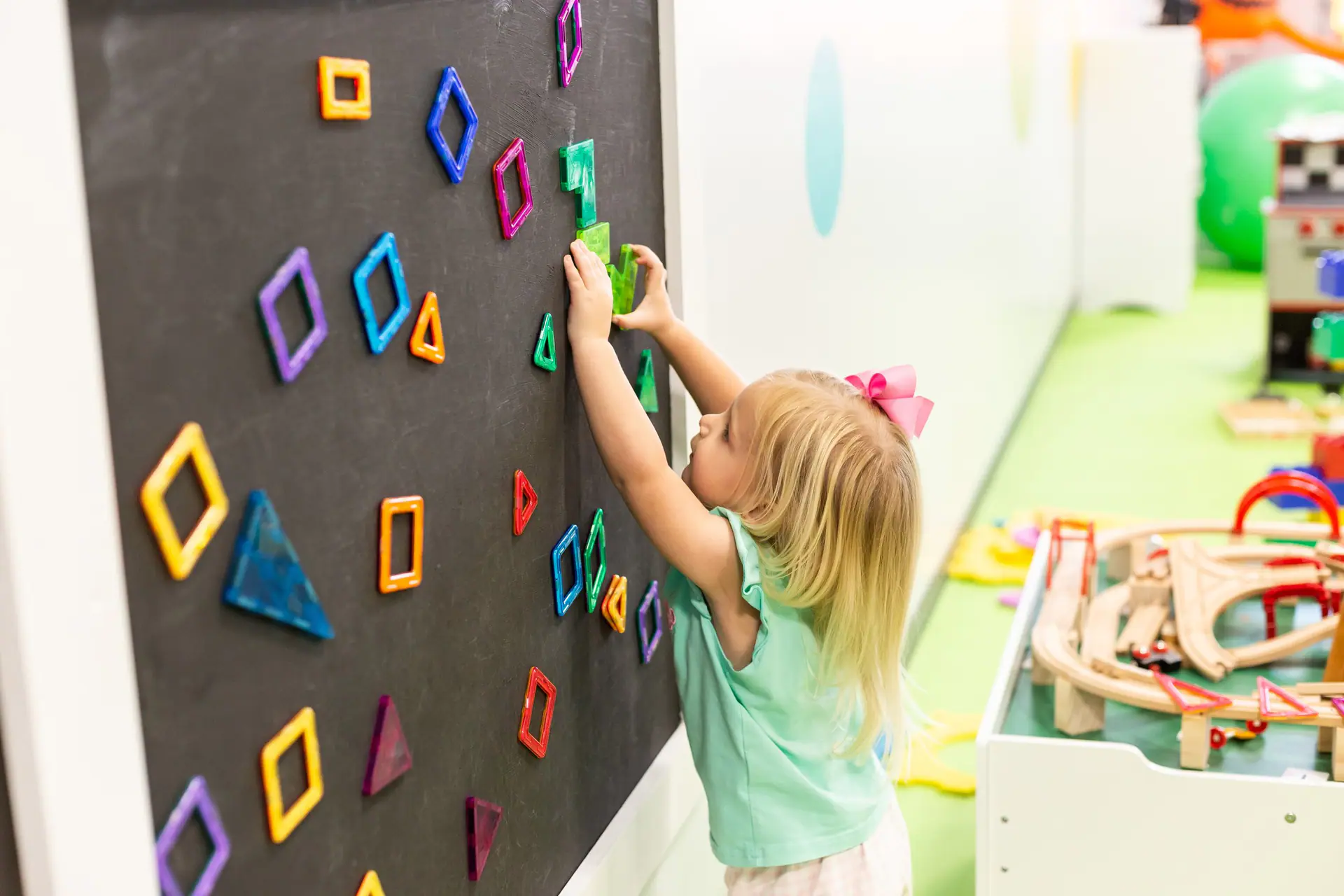 Indoor activity wall and play details at Chee Chee's Playroom.