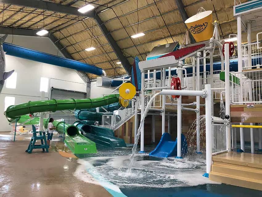 Wide view of Splash Shack's main indoor water-play structure and slide area.