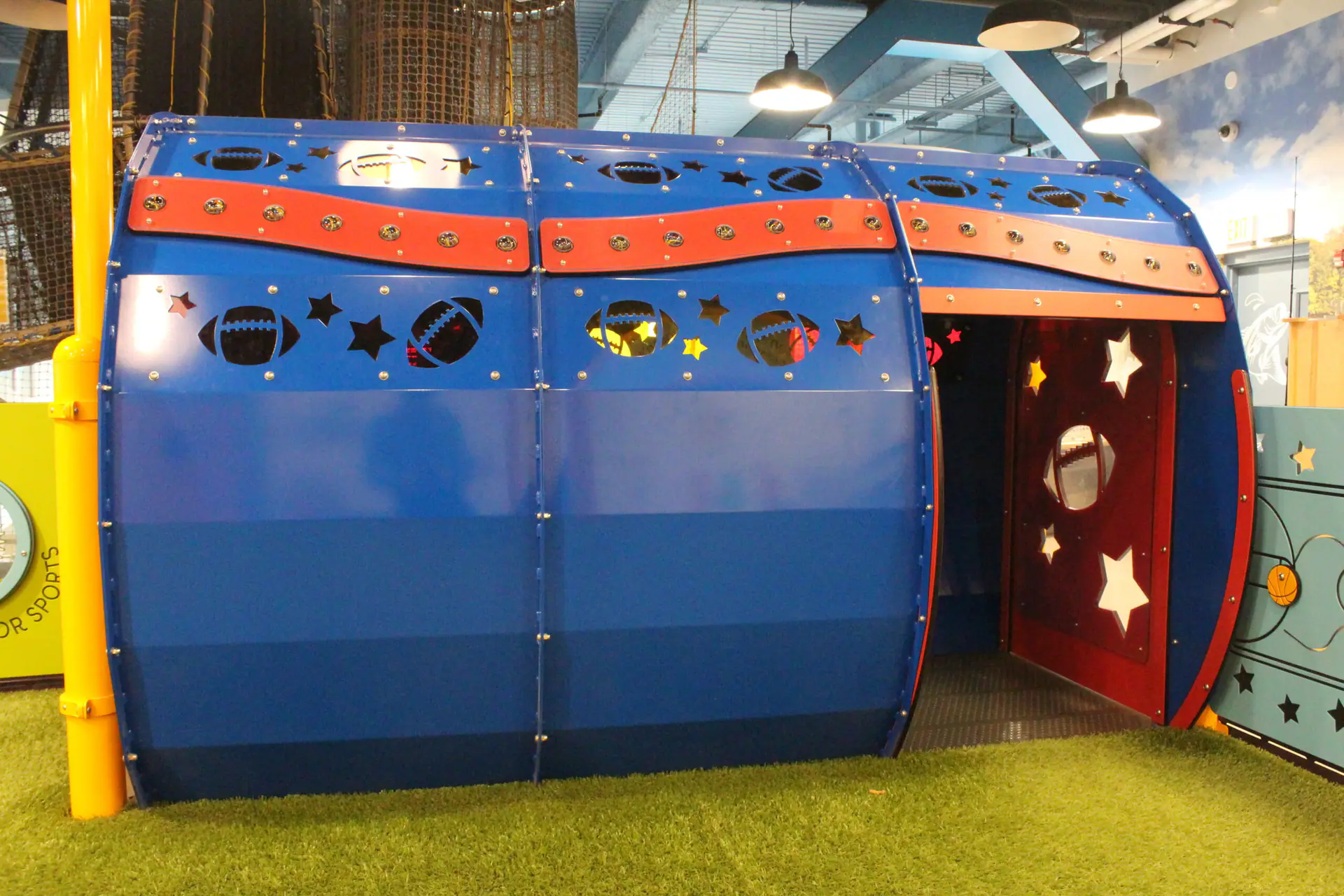 Families exploring a large hands-on exhibit area at Explore & More.