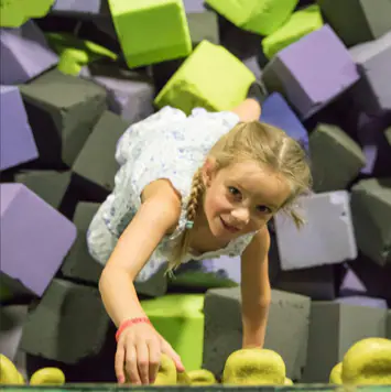 Kids jumping on trampolines inside Get Air Tucson's indoor adventure park