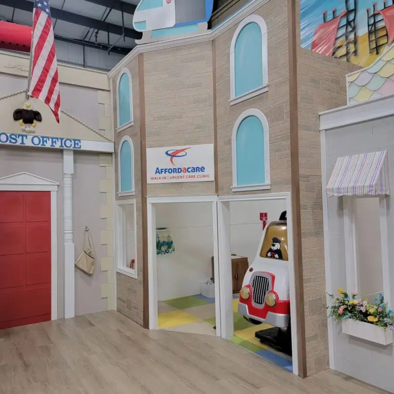 Clinic and emergency-vehicle pretend-play area inside CurioCity.