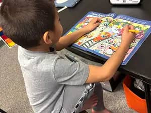 Young child working on a hands-on activity at CrunchTime Collective