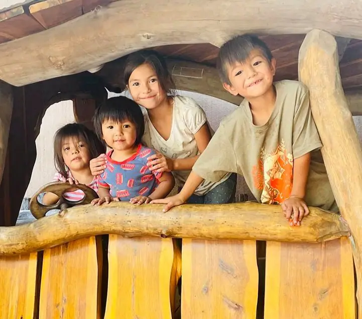 Children playing in Twirl's imaginative hobbit-style structure.
