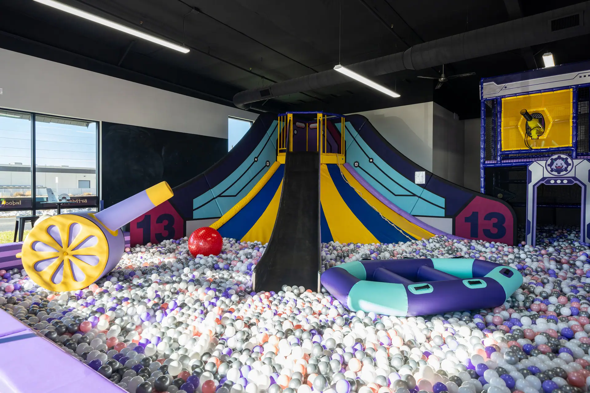 Large slide and ball-pit area at Lil Monsters Playground.