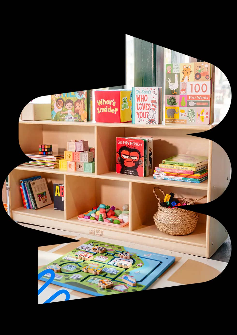 A child-friendly indoor play area with low shelves and imaginative play stations at WonderPlay.